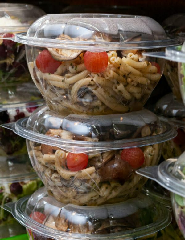 A closeup shot of tasty food in plastic containers in the shop